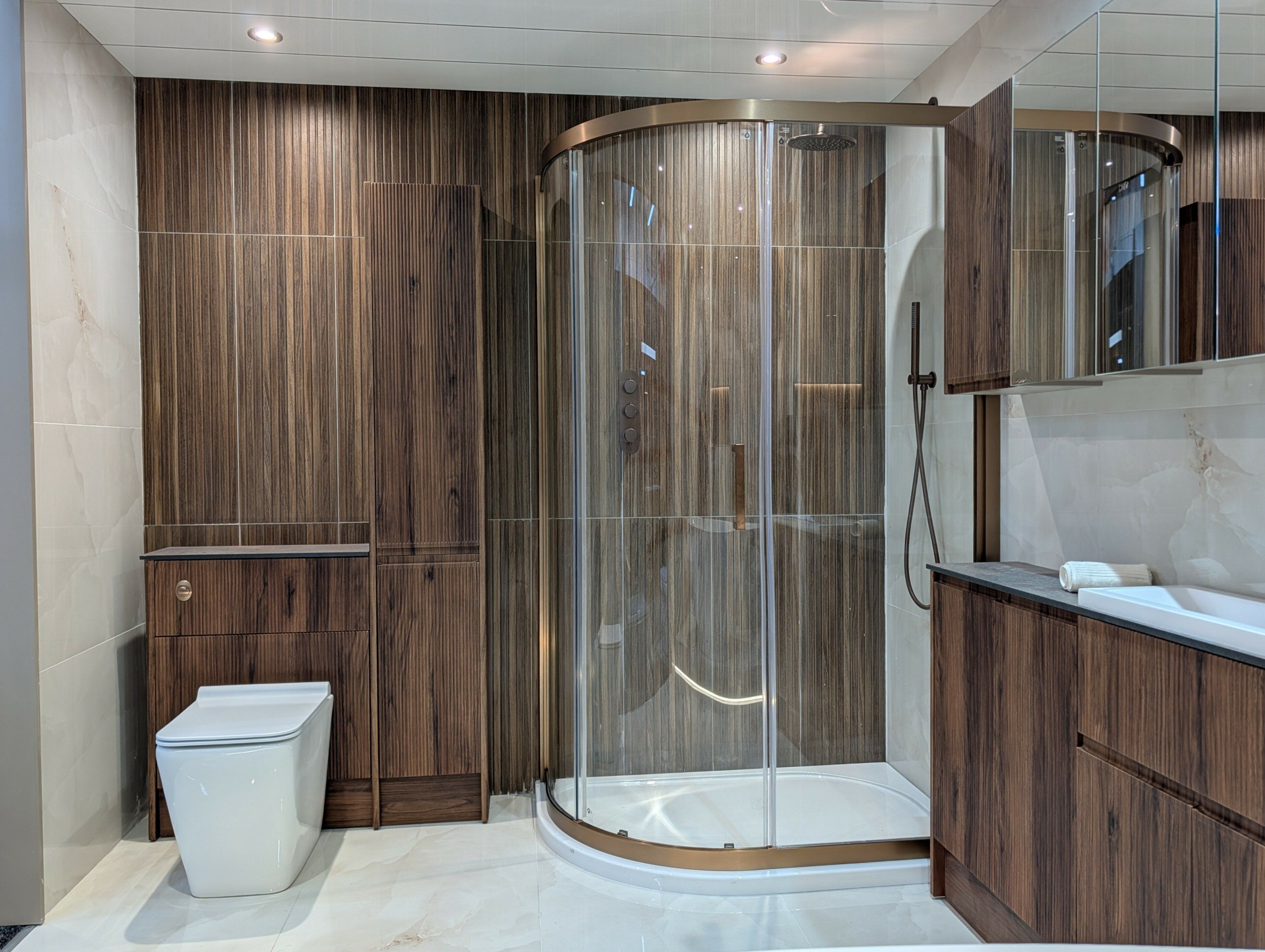 Wood effect bathroom with brushed metal trims and free standing bath at Easy Bathrooms Portsmouth