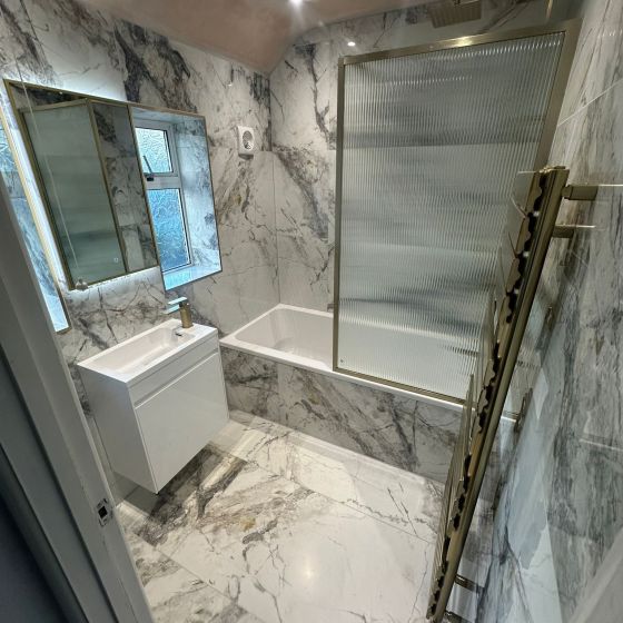 Brushed Gold Framed Fluted Glass Bath Screen