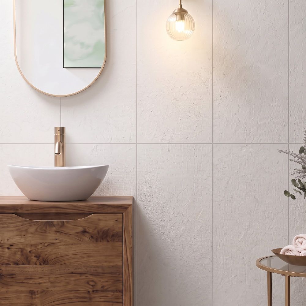 Modern bathroom wall vertically tiled in Kenya Blanco Ceramic Wall Tiles behind a wooden vanity with brass mixer.