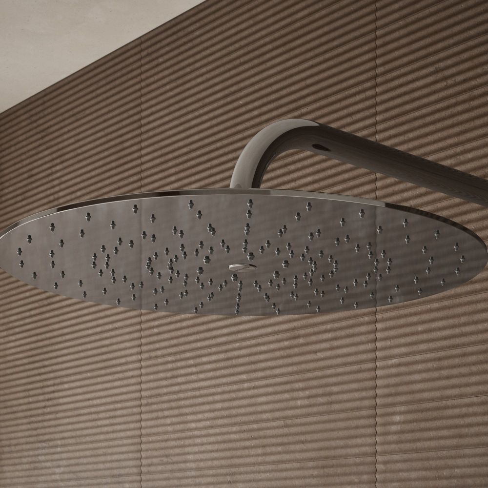 Aqualisa S3 chrome Wall Fixed Shower Head detailed view upon a brown tiled background