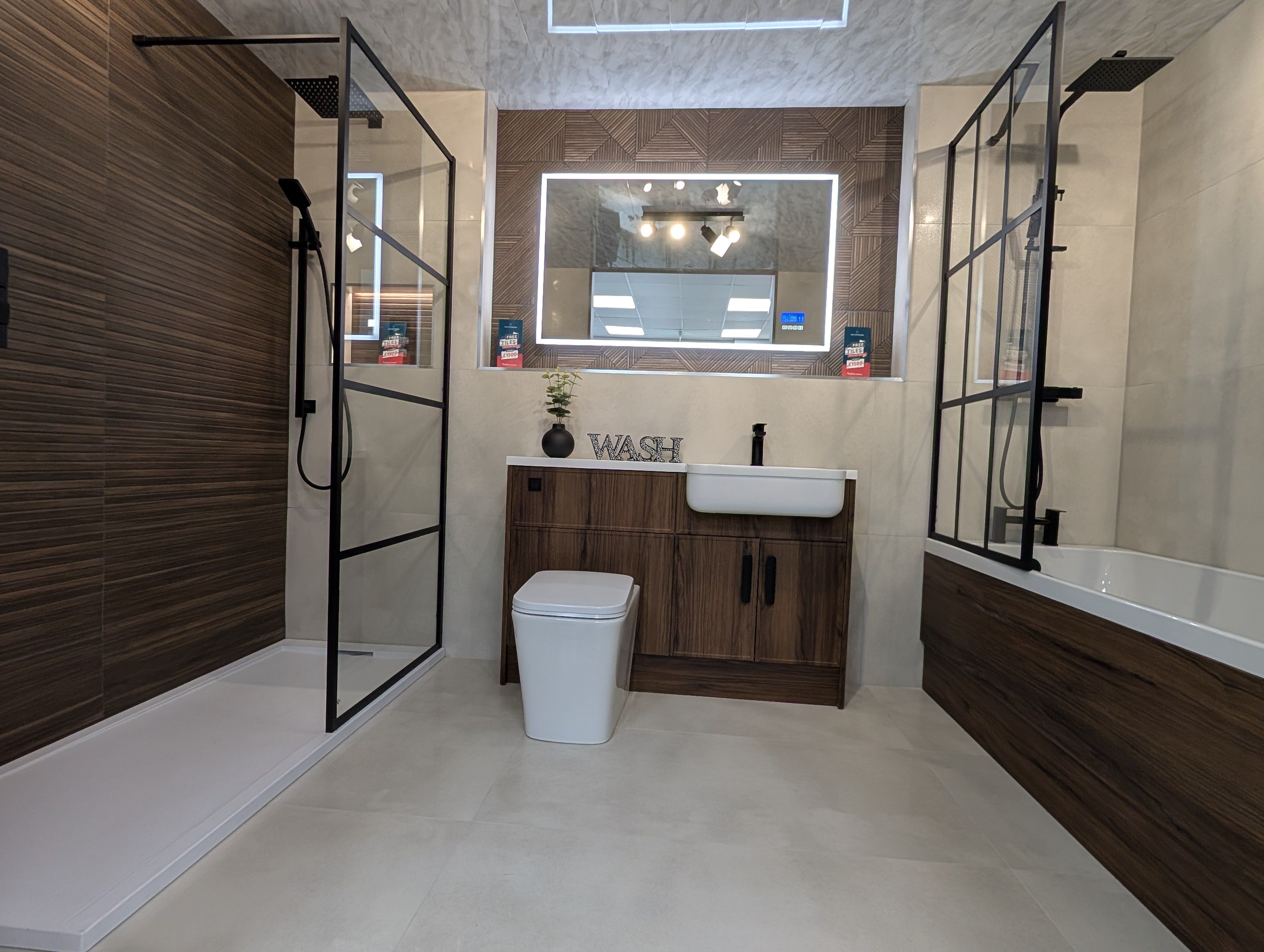 Boutique-style bathroom display with walnut-effect tiles, fitted furniture, a walk-in shower and modern white basin at the Easy Bathrooms Stoke-on-Trent showroom.
