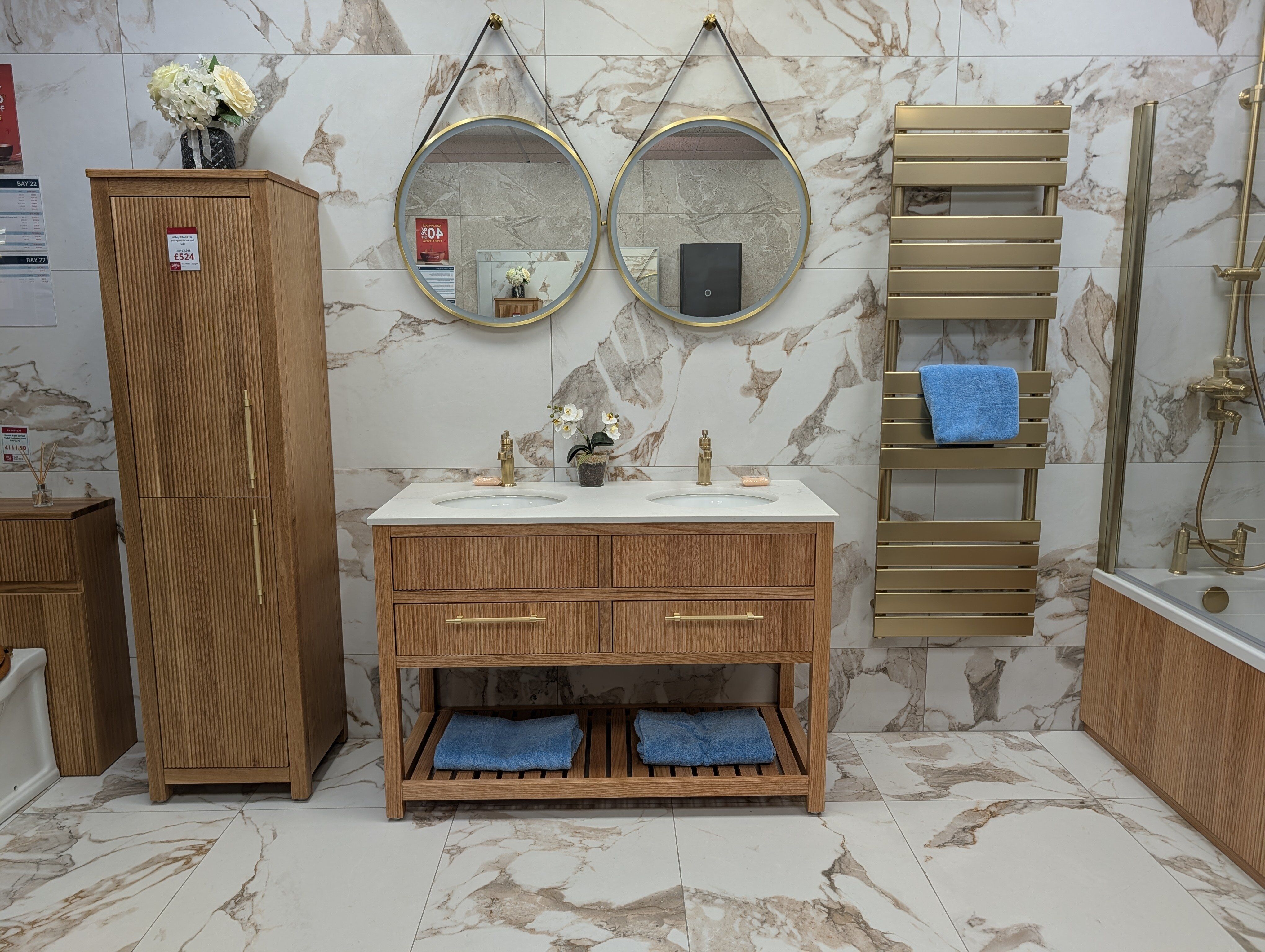 Spa-inspired bathroom display at Easy Bathrooms Fareham featuring a double wood-effect vanity, matching storage and large mirrors.