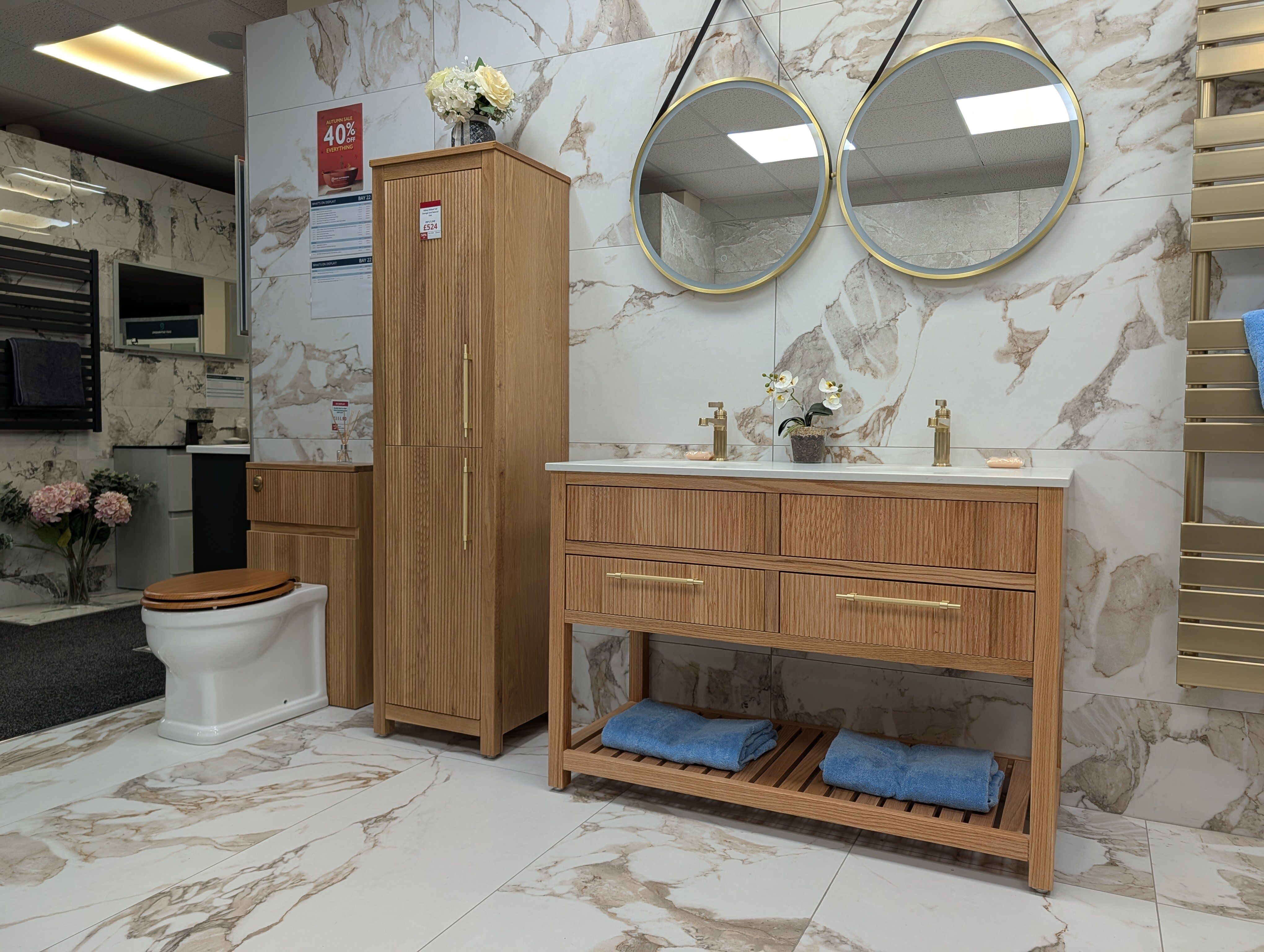 Warm wood bathroom furniture display at Easy Bathrooms Fareham with double basins and coordinated storage.