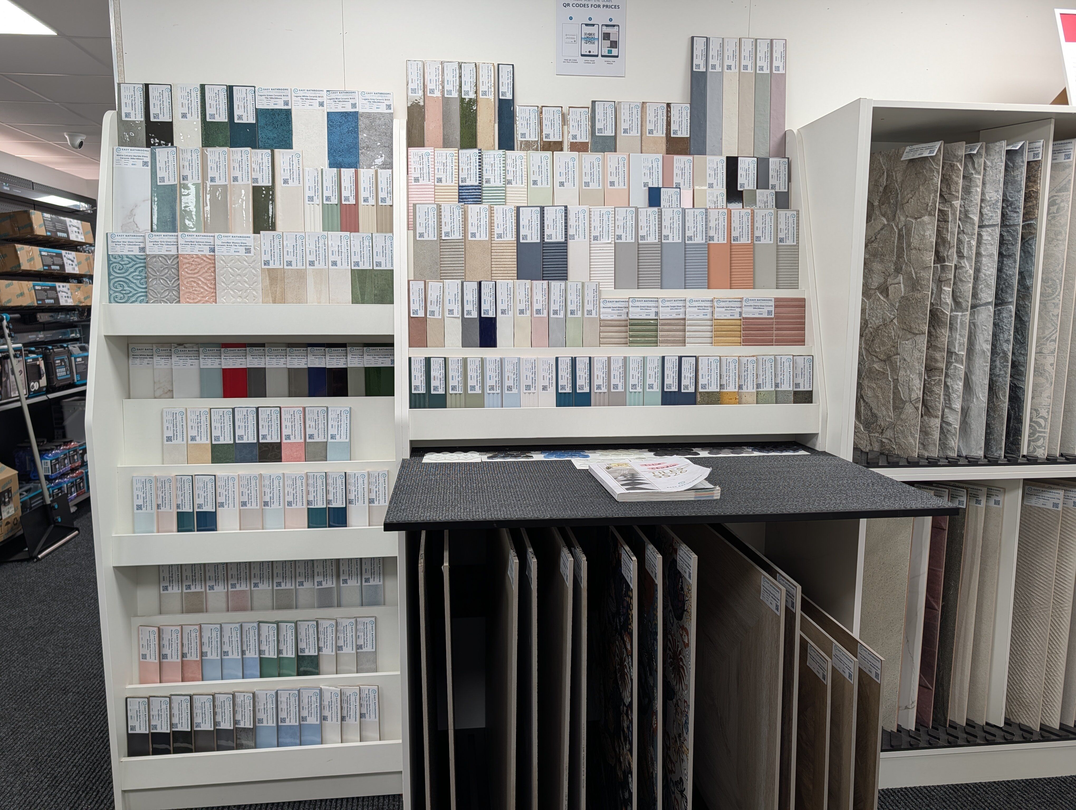 Tile sample display at Easy Bathrooms Portsmouth showing a wide range of colours, patterns and finishes.