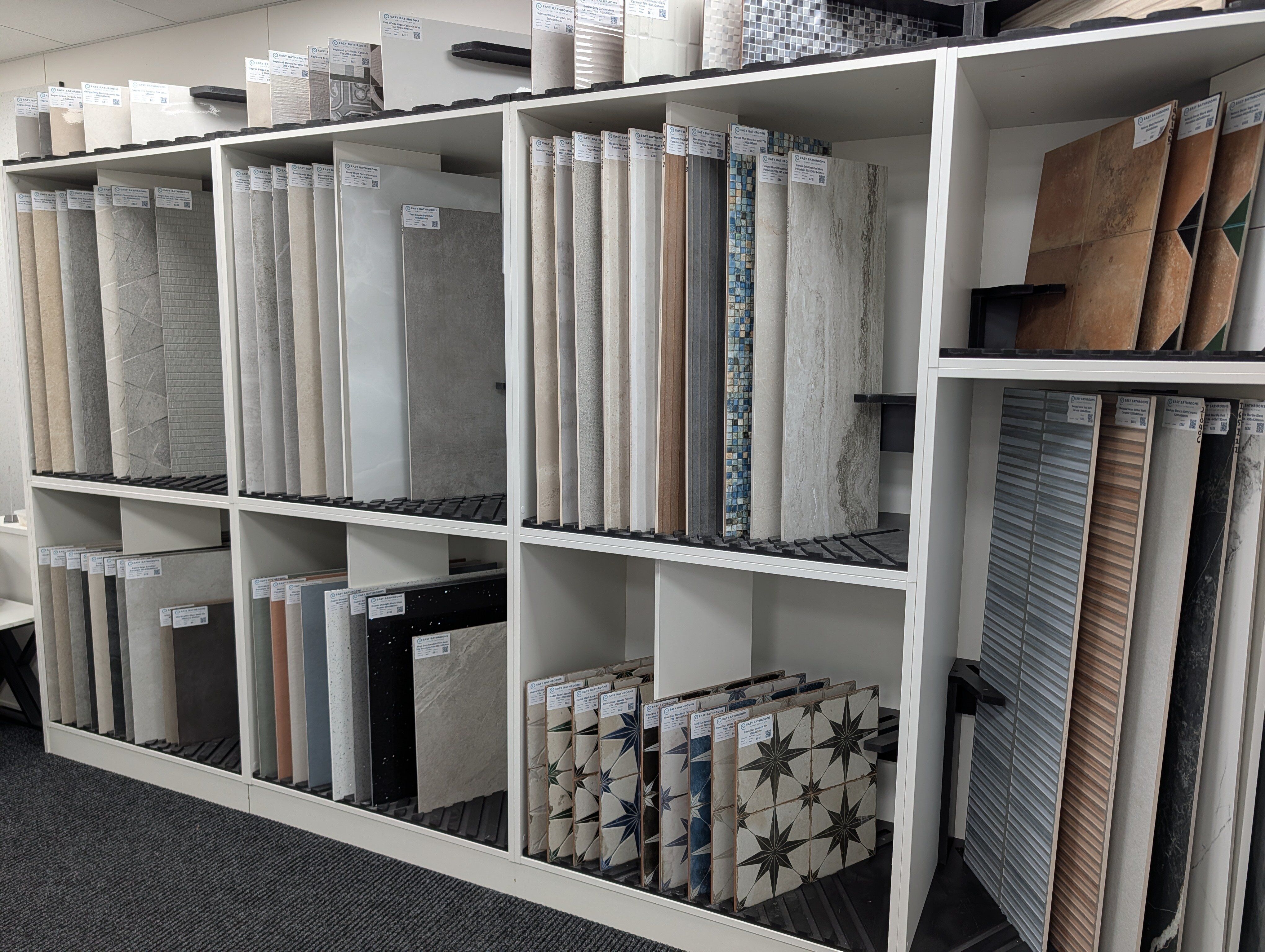 Bathroom tile displays at Easy Bathrooms Portsmouth featuring neutral, patterned and textured tile options.