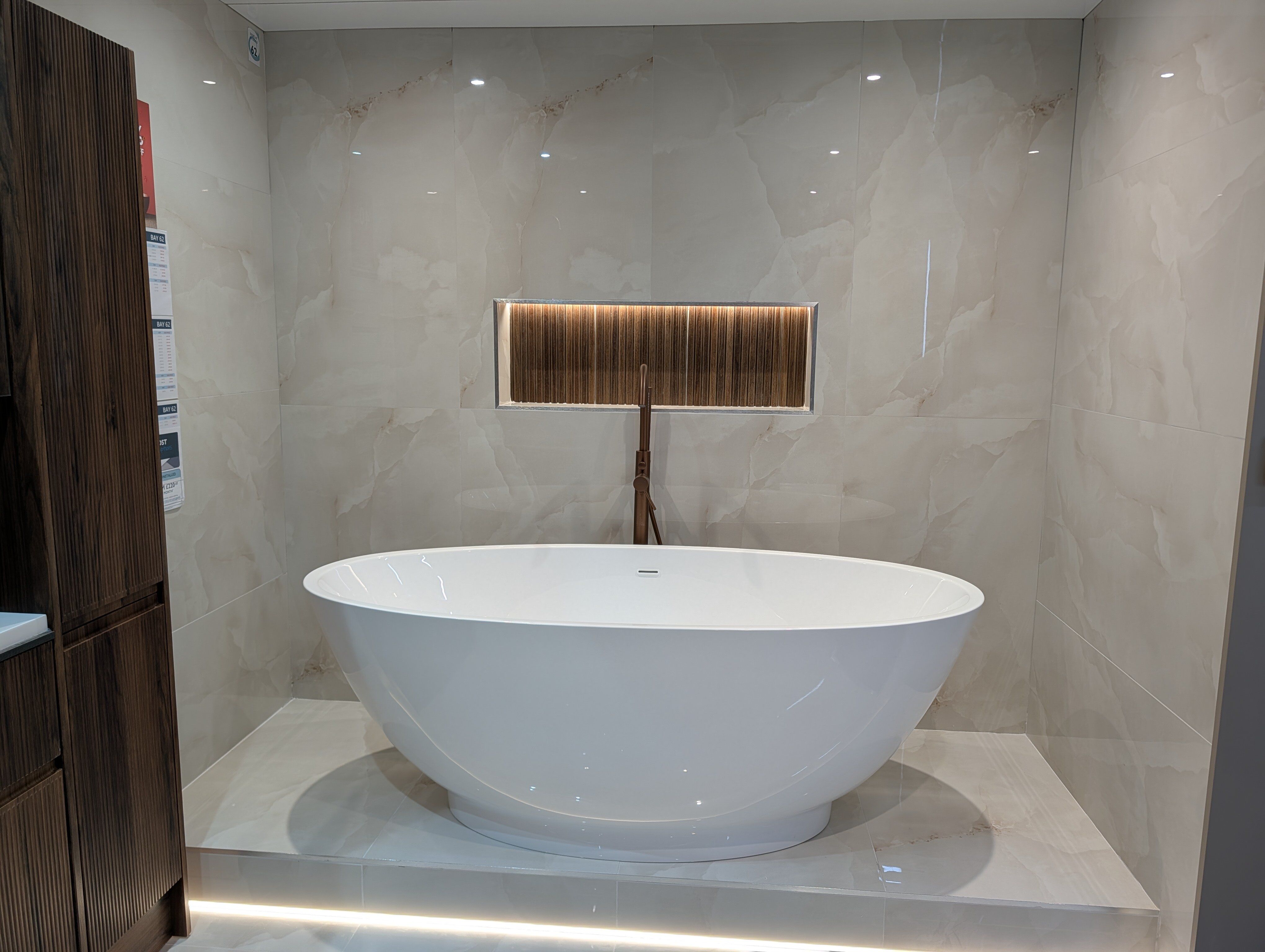 Modern free standing bath with recess for storage at Easy Bathrooms & Tiles Portsmouth