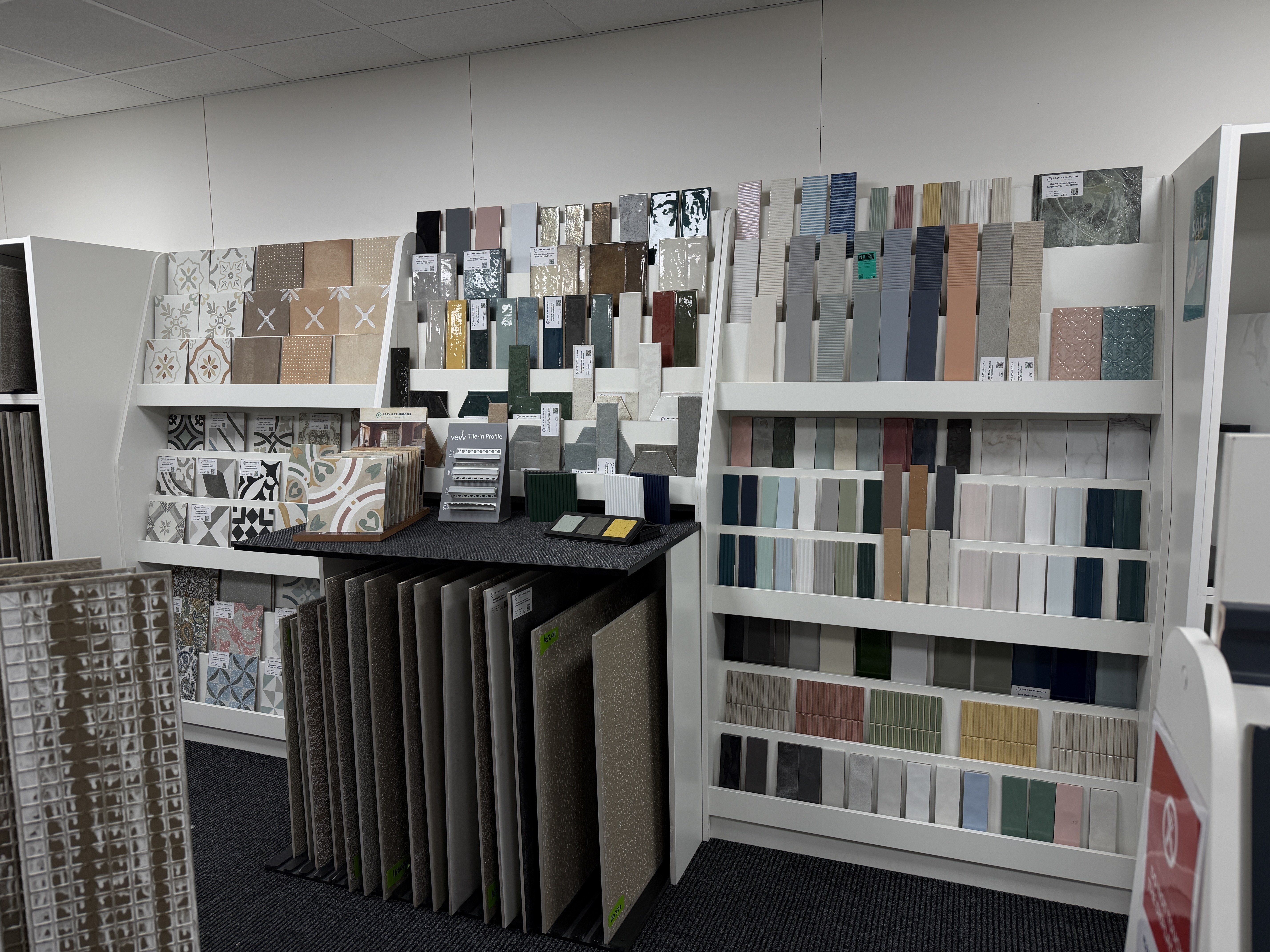 Tile showroom display featuring patterned, metro, mosaic and textured wall tile samples in a wide range of colours and finishes.
