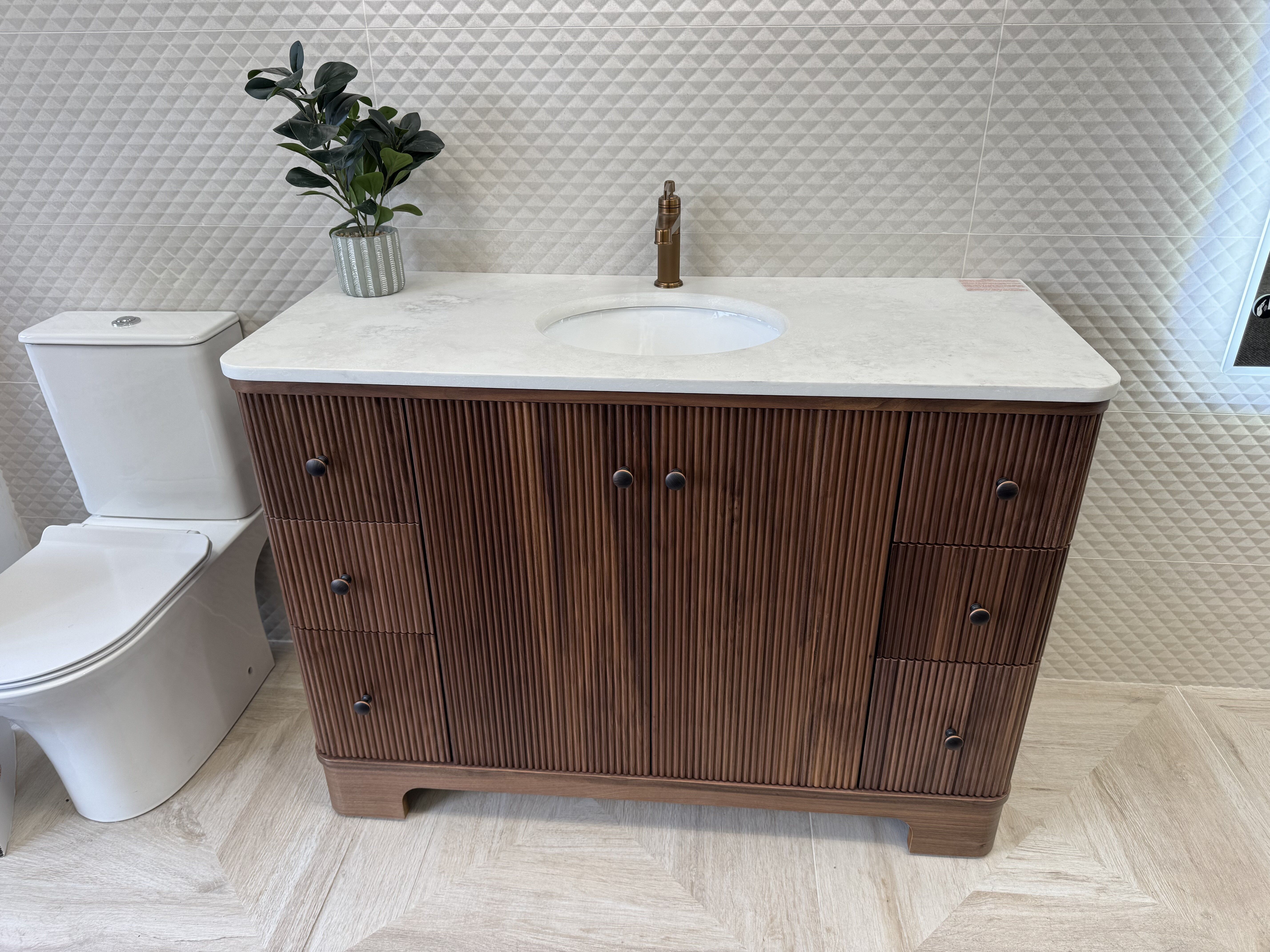 Hayward Walnut ribbed floorstanding vanity unit with brushed bronze knobs and white basin at the Rayleigh showroom.