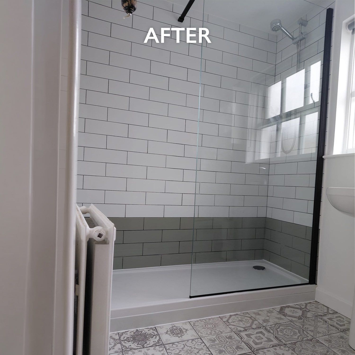 After photo showing the new walk-in shower with clear glass screen, white metro tiles, grey feature tiles and patterned bathroom flooring.