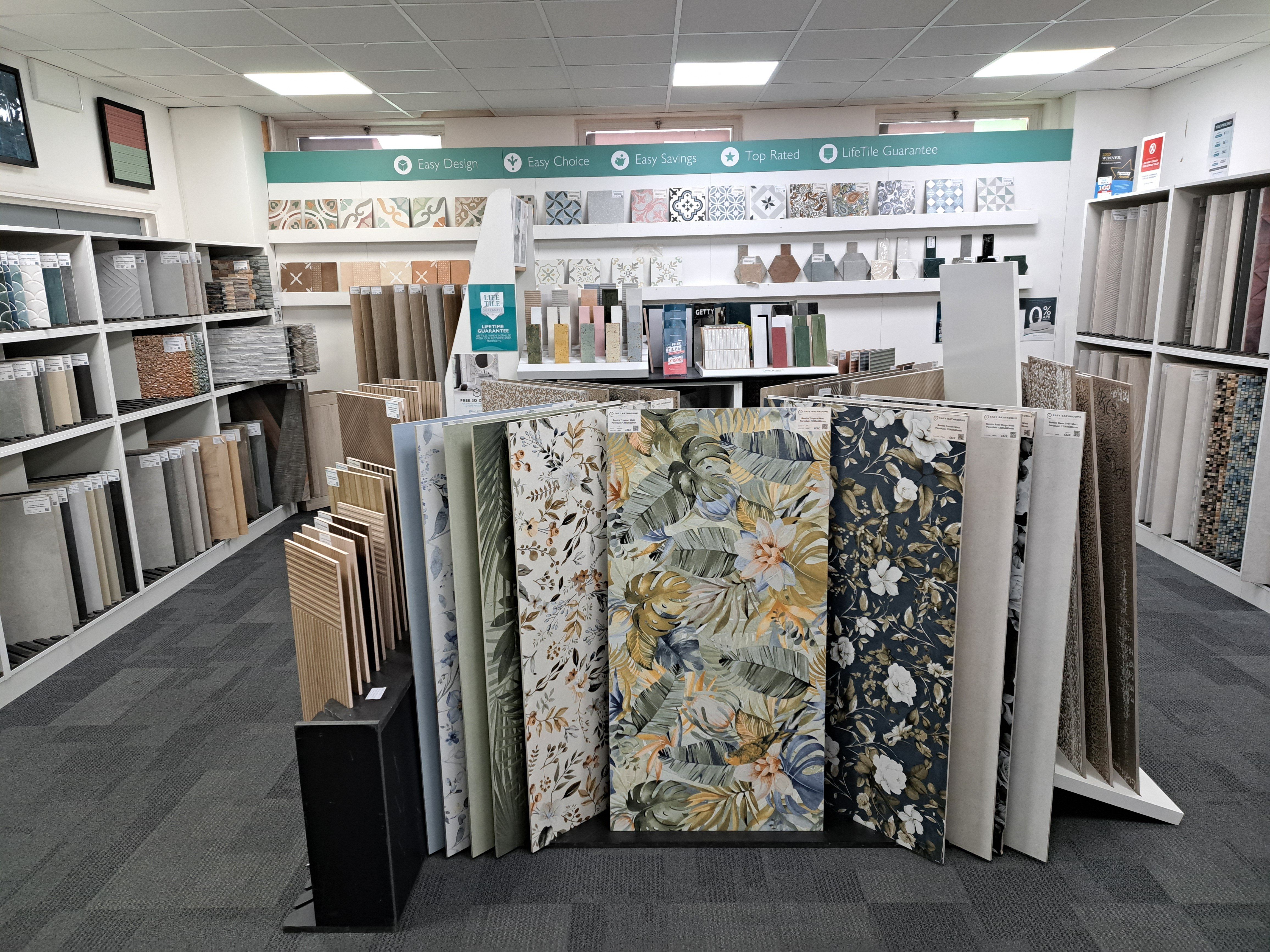 Tile sample displays showing a wide choice of patterned, plain and textured tiles at the Easy Bathrooms Weybridge showroom.