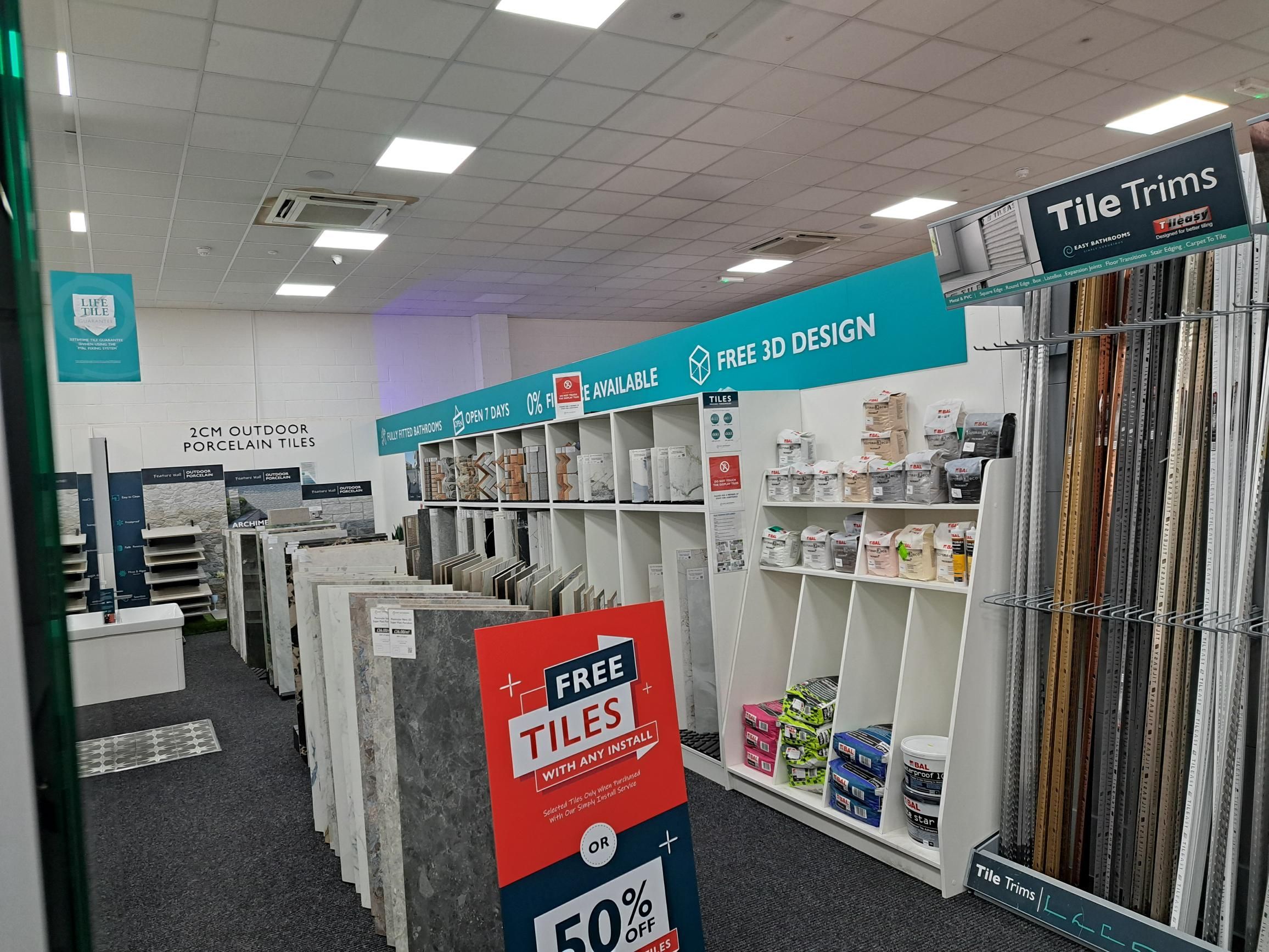 Tile Studio at the Easy Bathrooms Weybridge showroom with large wall and floor tile samples on display.