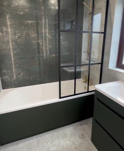 distressed concrete tiles paired with modern shower screen and bath shower combo