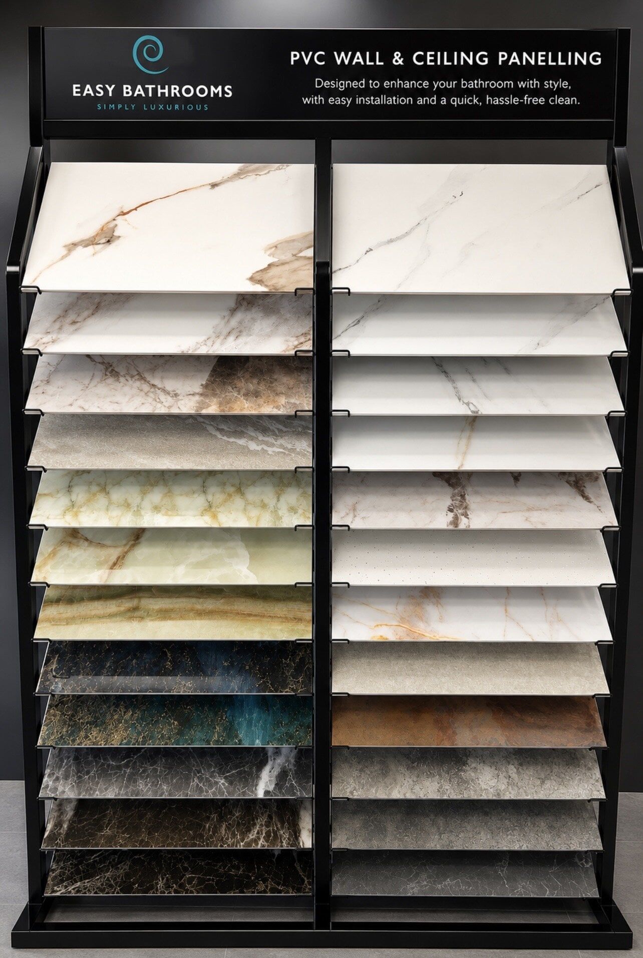 Pristina PVC bathroom wall panel sample display at Easy Bathrooms Beckton, showing a range of neutral, marble-effect and textured finishes.