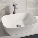 Lifestyle image showing the Zena Chrome Tall Basin Mixer Tap at the side of a countertop basin