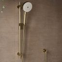 Aqualisa S3 Gold Slide Rail Kit detailed view upon a brown tiled background