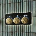 Aqualisa S3 Gold Horizontal Controls detailed view upon a teal tiled background