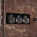 Aqualisa S3 Gunmetal Controls kon an brown tiled background