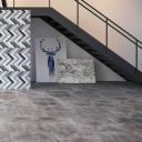 Discontinued Zero Smoke Matt Porcelain Tiles installed on a modern open-plan floor beneath a black metal staircase.