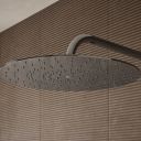 Aqualisa S3 chrome Wall Fixed Shower Head detailed view upon a brown tiled background
