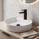 black sleek square tap and waste on top of round basin