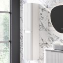 White marble roomset showcasing the Soar Ribbed White Wall Mounted Tall Storage Cabinet