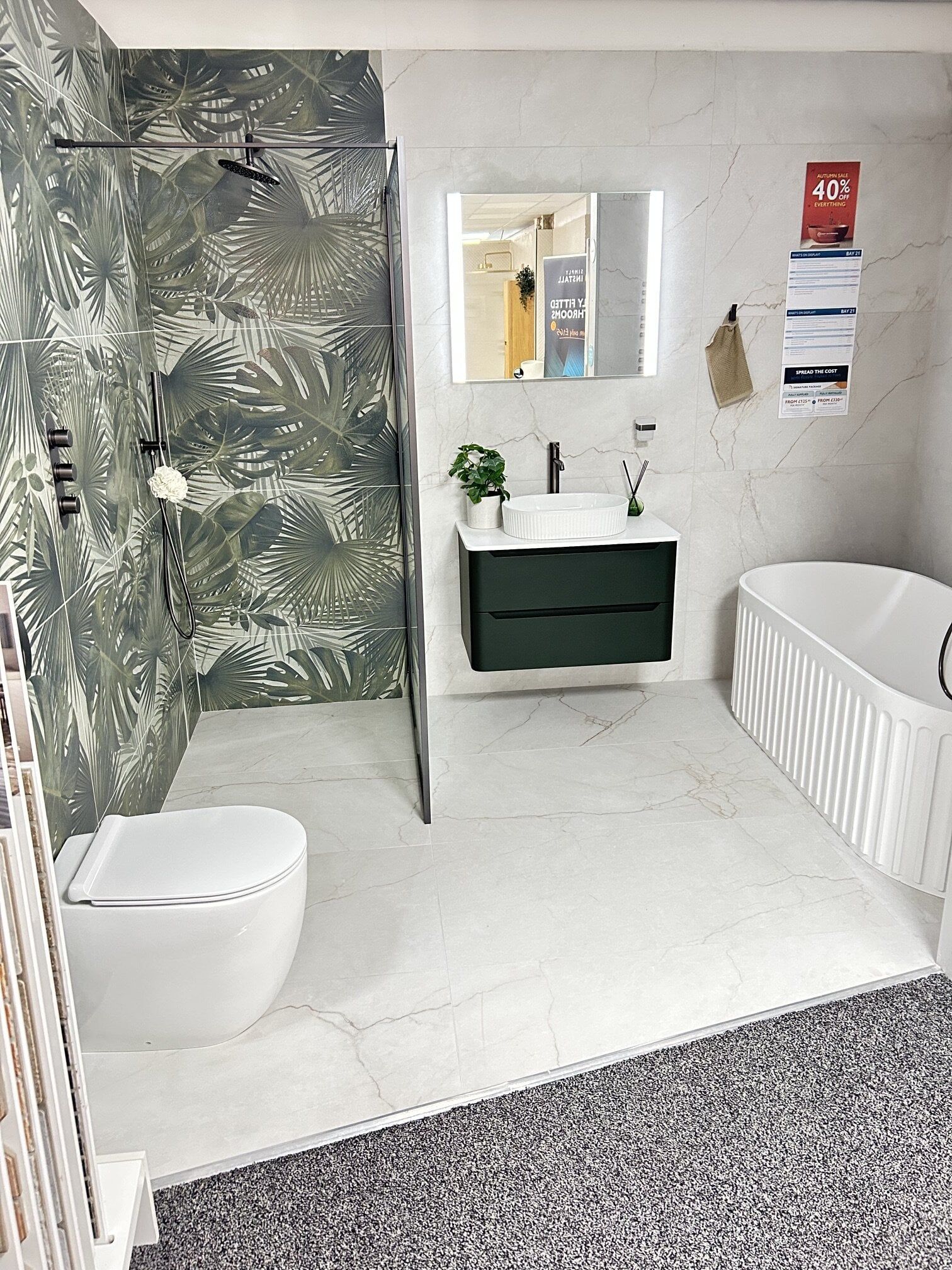 Jungle leaf display tiles with green bathroom furniture featuring walk in shower and freestanding bath