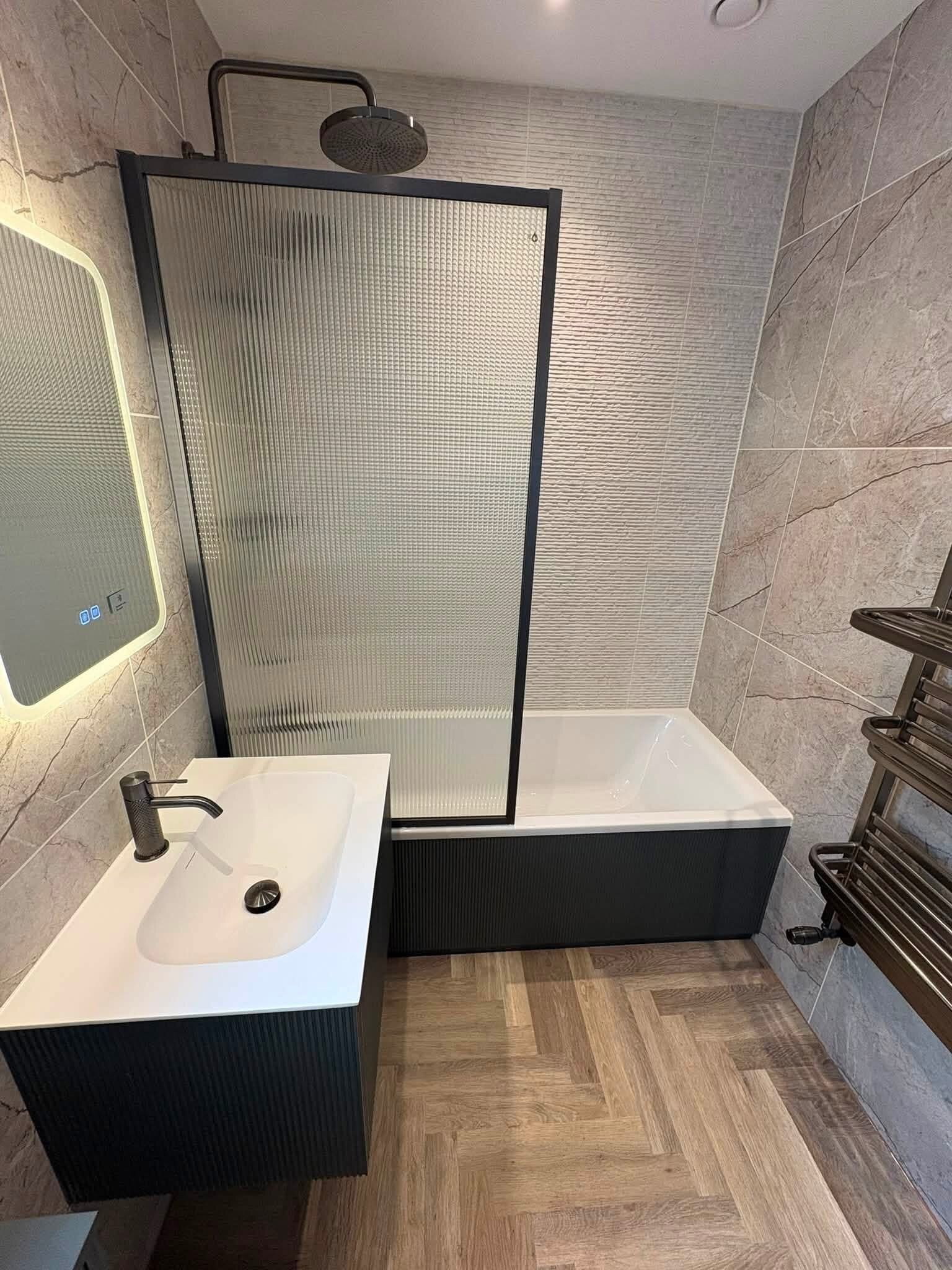 Finished bathroom supplied by Easy Bathrooms Portsmouth with walk-in shower, vanity unit and warm neutral finishes.
