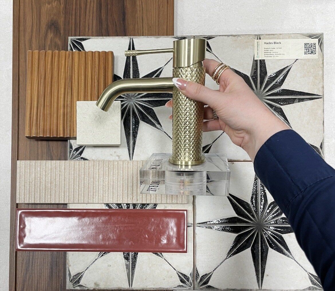 Bathroom design mood board featuring earthy tile samples, statement colours and coordinating brassware.