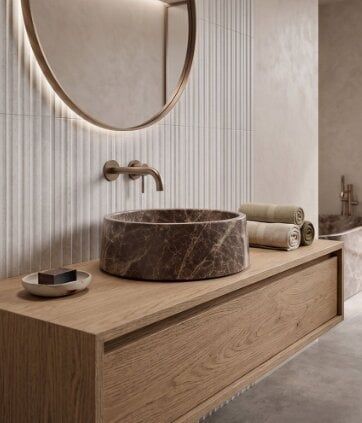 Textured stone-effect countertop basin styled on a wood vanity unit at Easy Bathrooms Crawley.