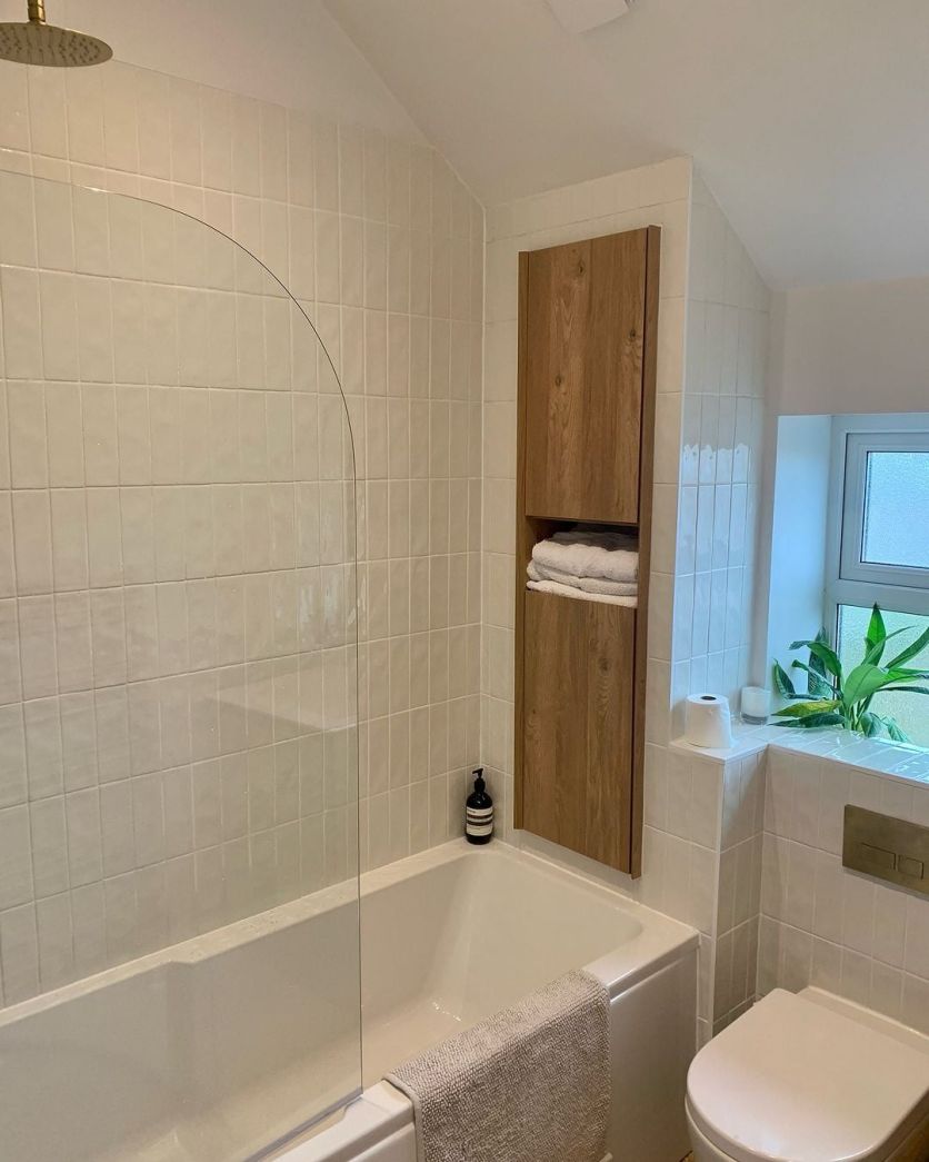 small white bathroom with wood accents