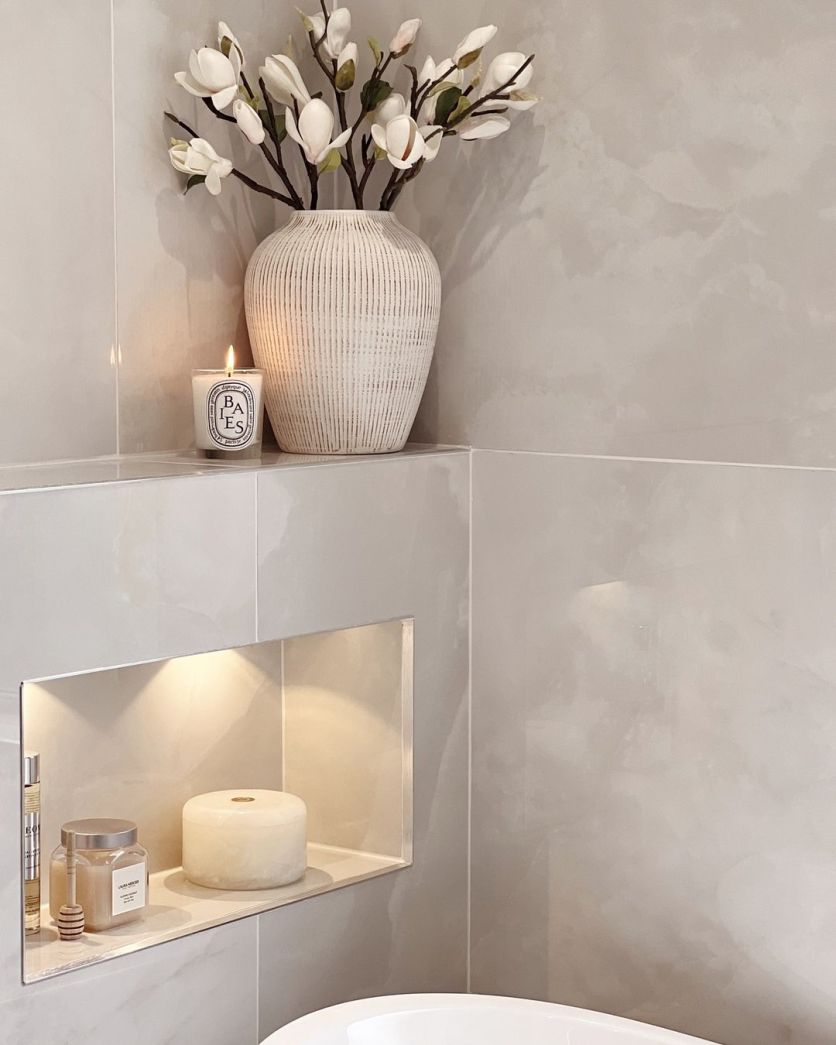Osaka white polished onyx tiles frame a Jackoboard recessed niche with warm, integrated shelf lighting.