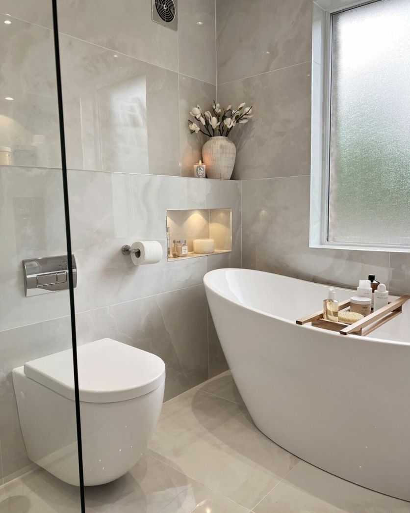 Lambi freestanding white bath and Oscar wall hung toilet paired with Osaka white polished tiles.
