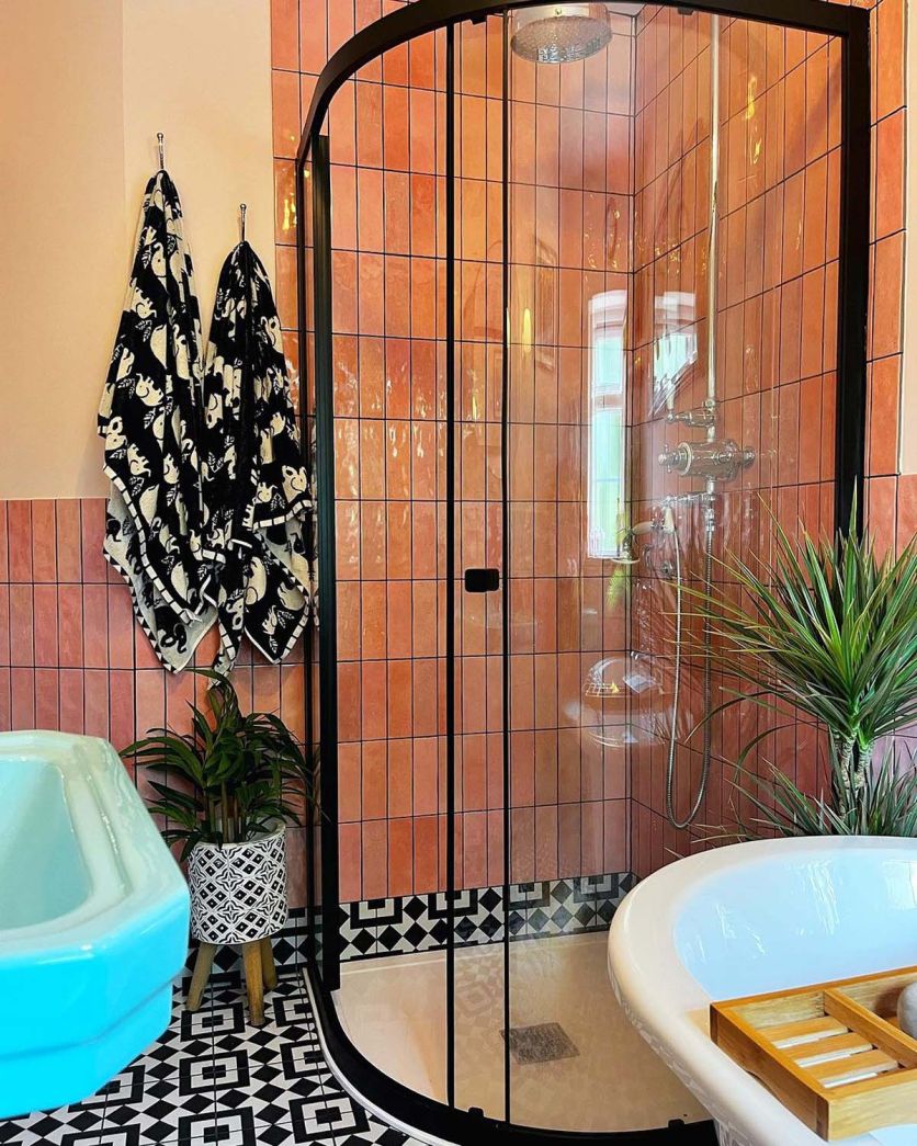 pink bathroom brick wall tiles with monochrome pattern wall tiles and black quadrant shower