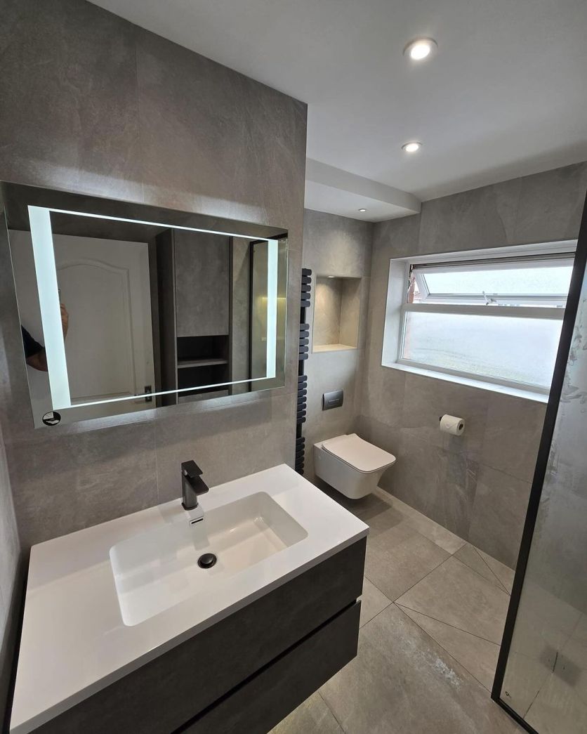 Galyn concrete vanity and Dinton LED mirror paired with a Zena gunmetal tap and Elbert wall hung toilet.