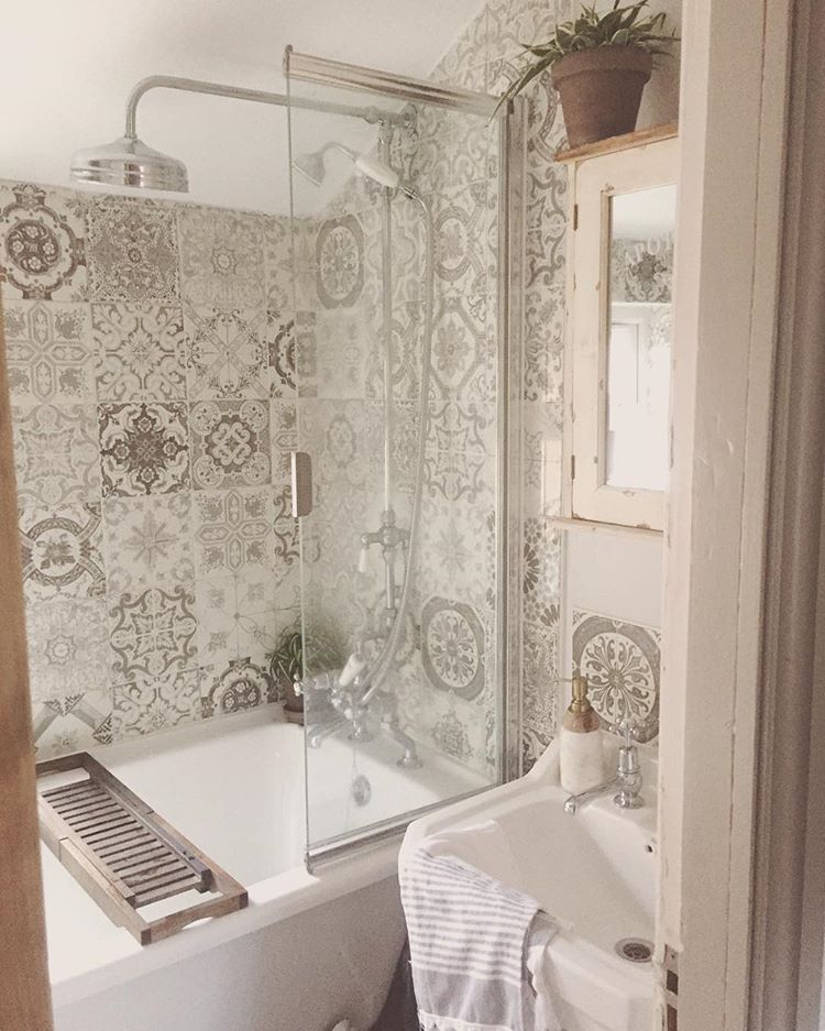 Traditional bathroom with grey patterned tiles, a pedestal basin and a bath-shower with vintage-style fixtures.