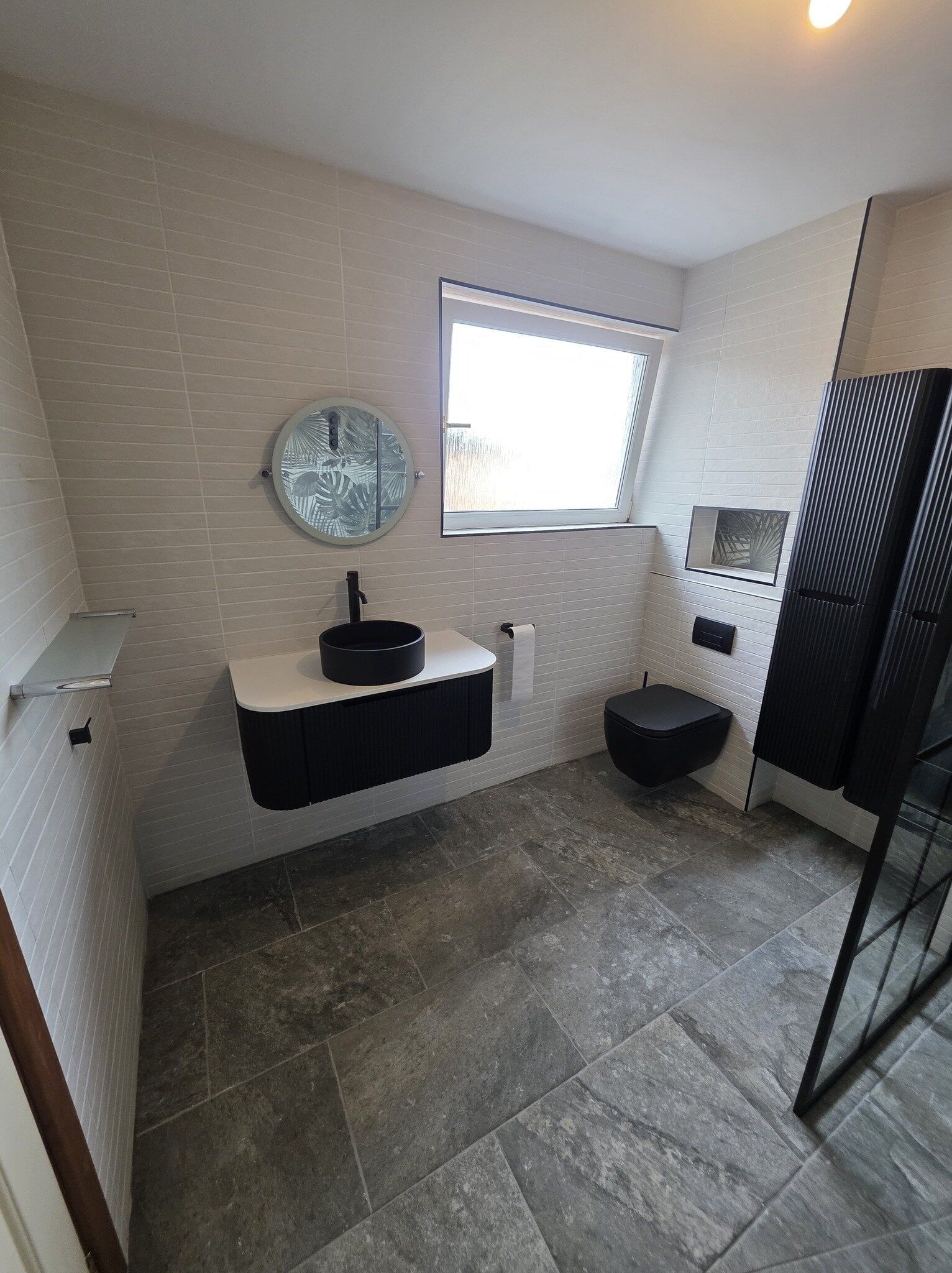 Modern accessible bathroom in Lincoln with wall-mounted vanity unit, mirror and spacious layout.