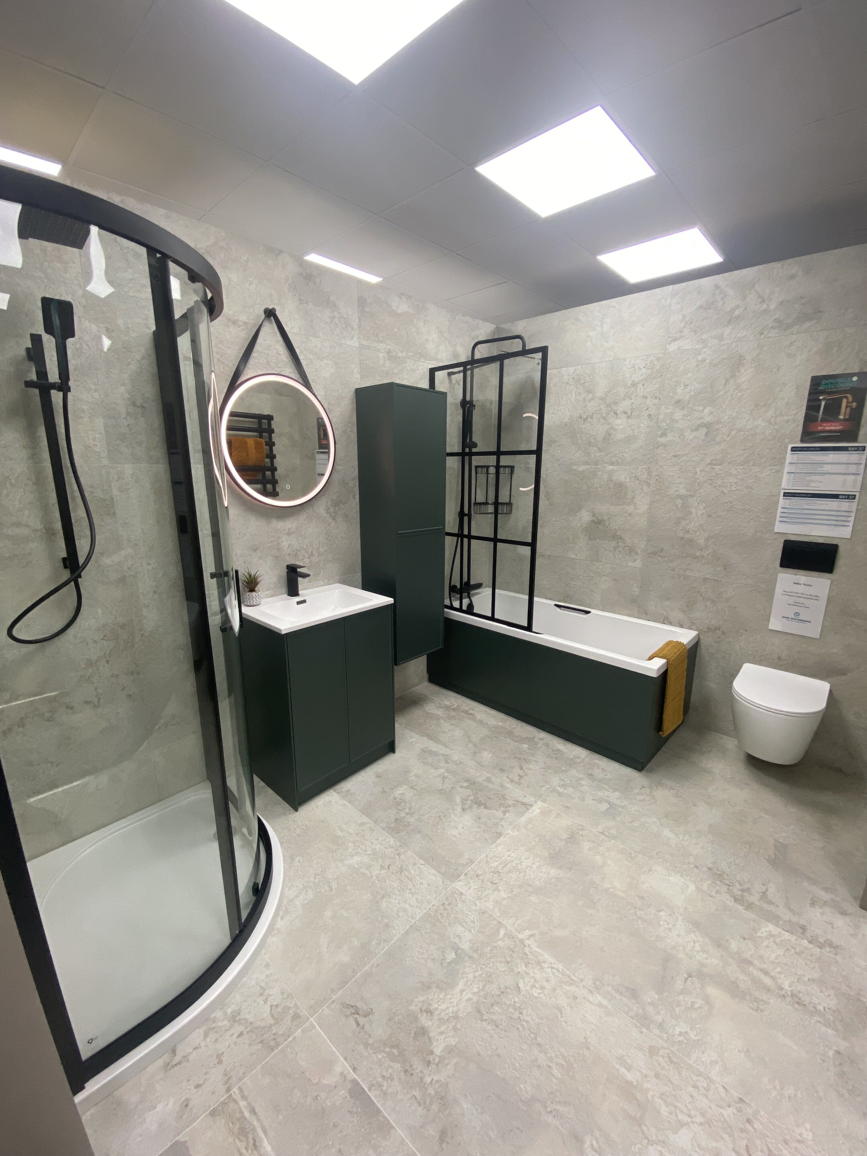Contemporary green bathroom display with black shower enclosure and coordinated furniture at Easy Bathrooms Newbury.