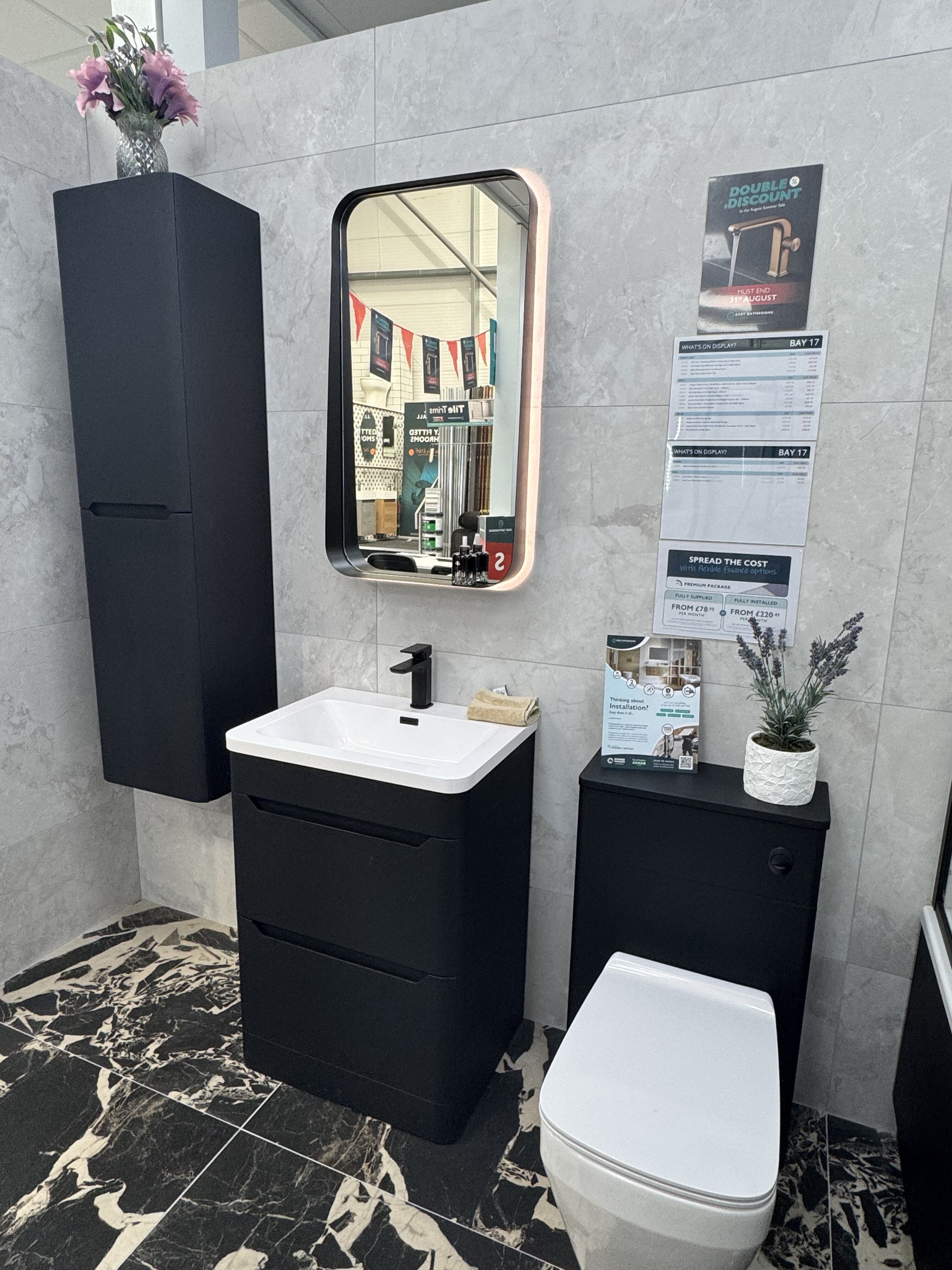 Black vanity unit, illuminated mirror and toilet within the new Leeds Seacroft showroom display.