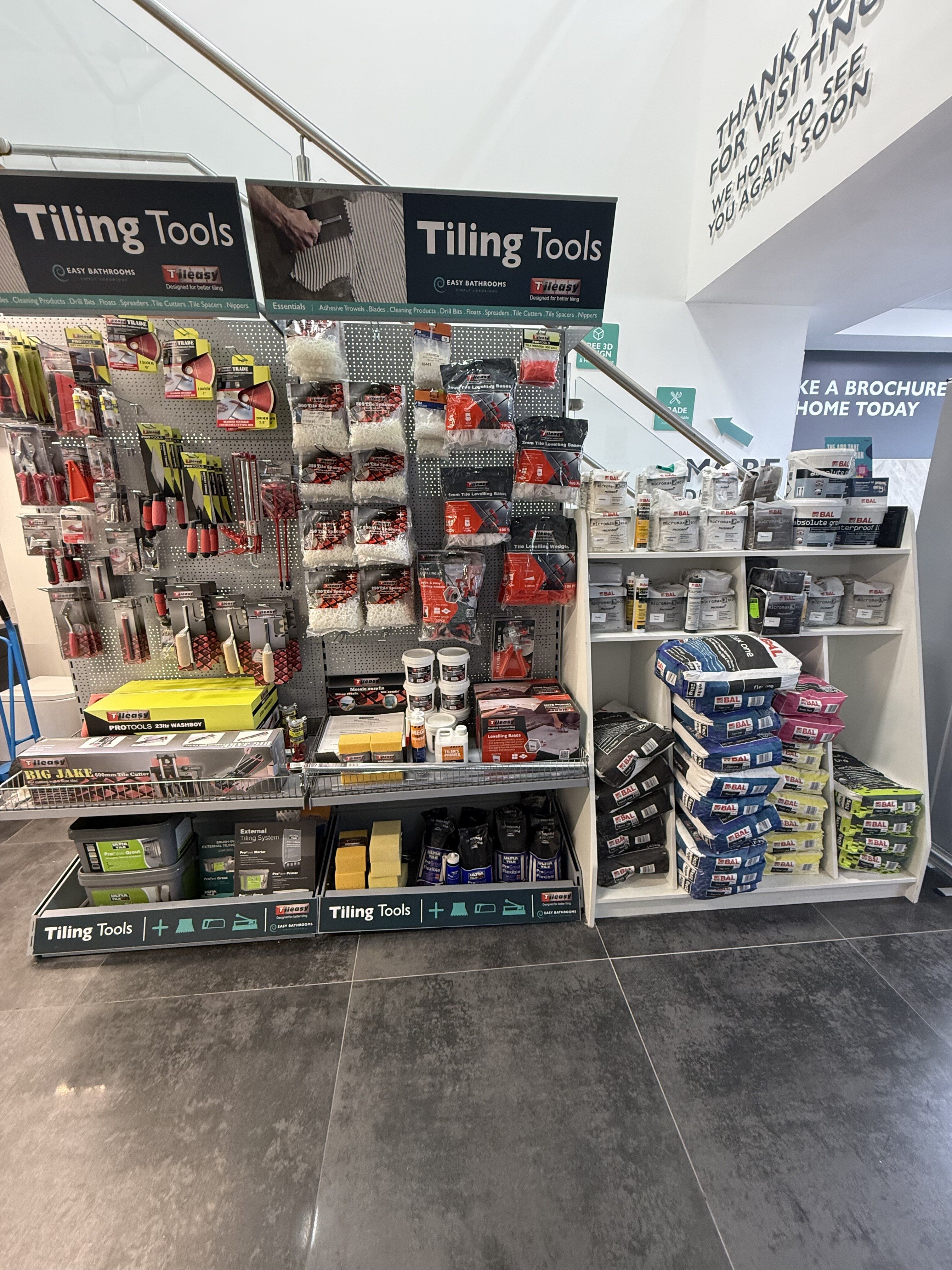 Tileasy and BAL tiling essentials display at Easy Bathrooms Romford featuring tools, trims, adhesives, grouts and trade products.