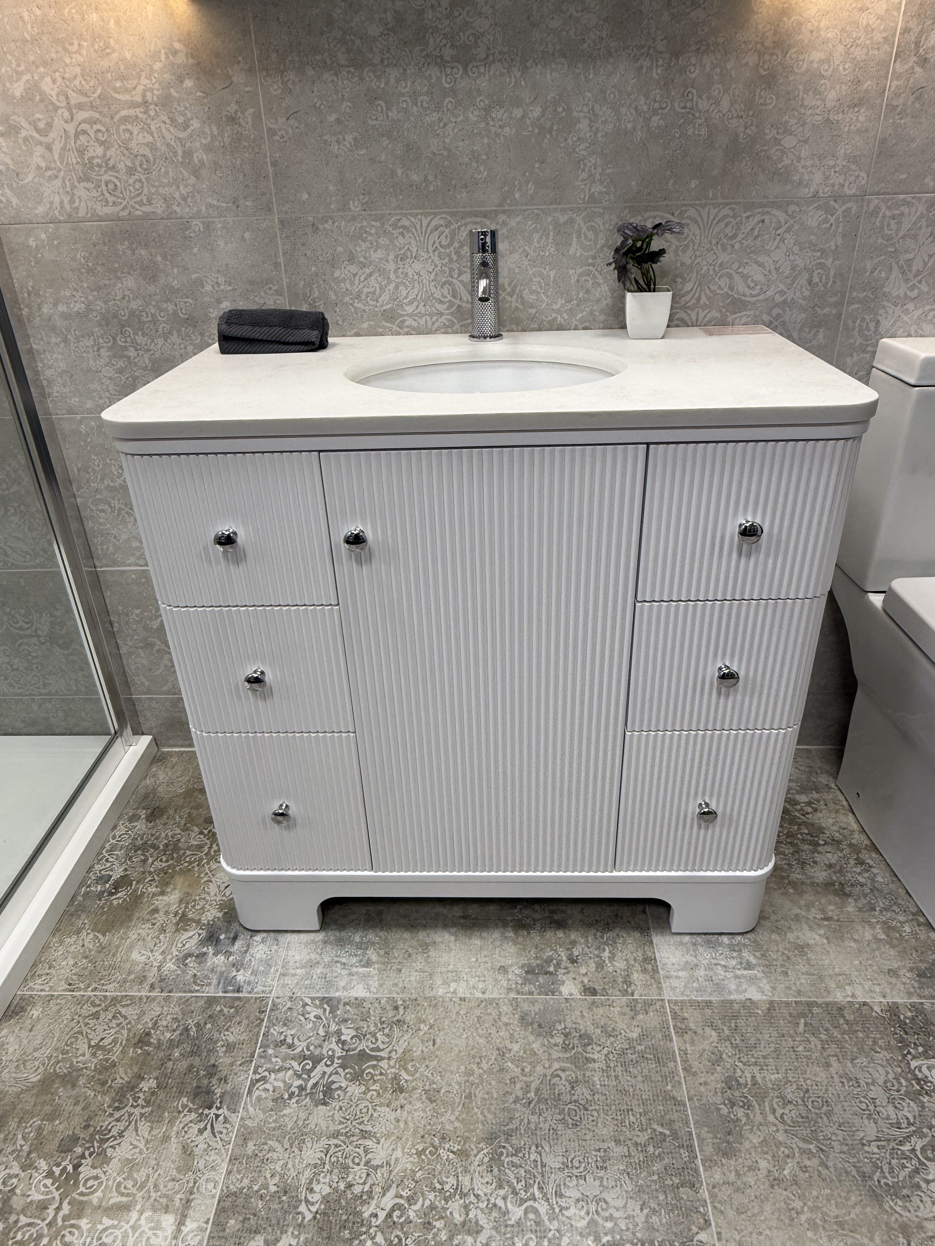 Close-up of the Hayward Matt White bathroom vanity unit with integrated storage, white basin and chrome brassware.