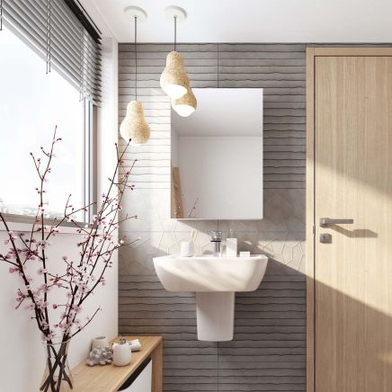 Modern bathroom vanity wall tiled in Moonlight Blind Ceniza Ceramic Tiles combined with Arkan geometric tiles behind a pedestal basin.