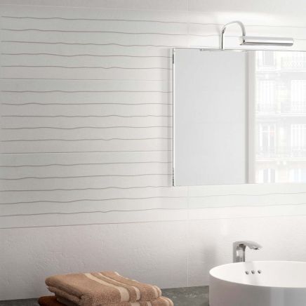 Modern bathroom vanity wall tiled in Kenya Blind Blanco Ceramic Tiles behind a mirror and basin.