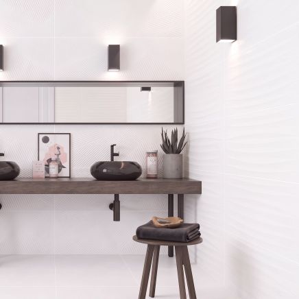 Modern spa-style bathroom with side wall tiled in Kenya Feel Blanco Wave 400x1200mm tiles and back wall in Kenya Axiom tiles.