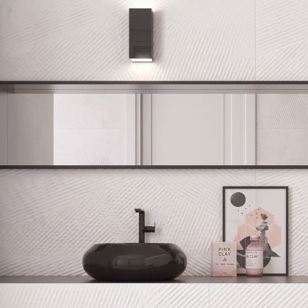 Modern bathroom vanity feature wall tiled in Kenya Axiom Blanco Wave Ceramic Tiles behind a black bowl sink.
