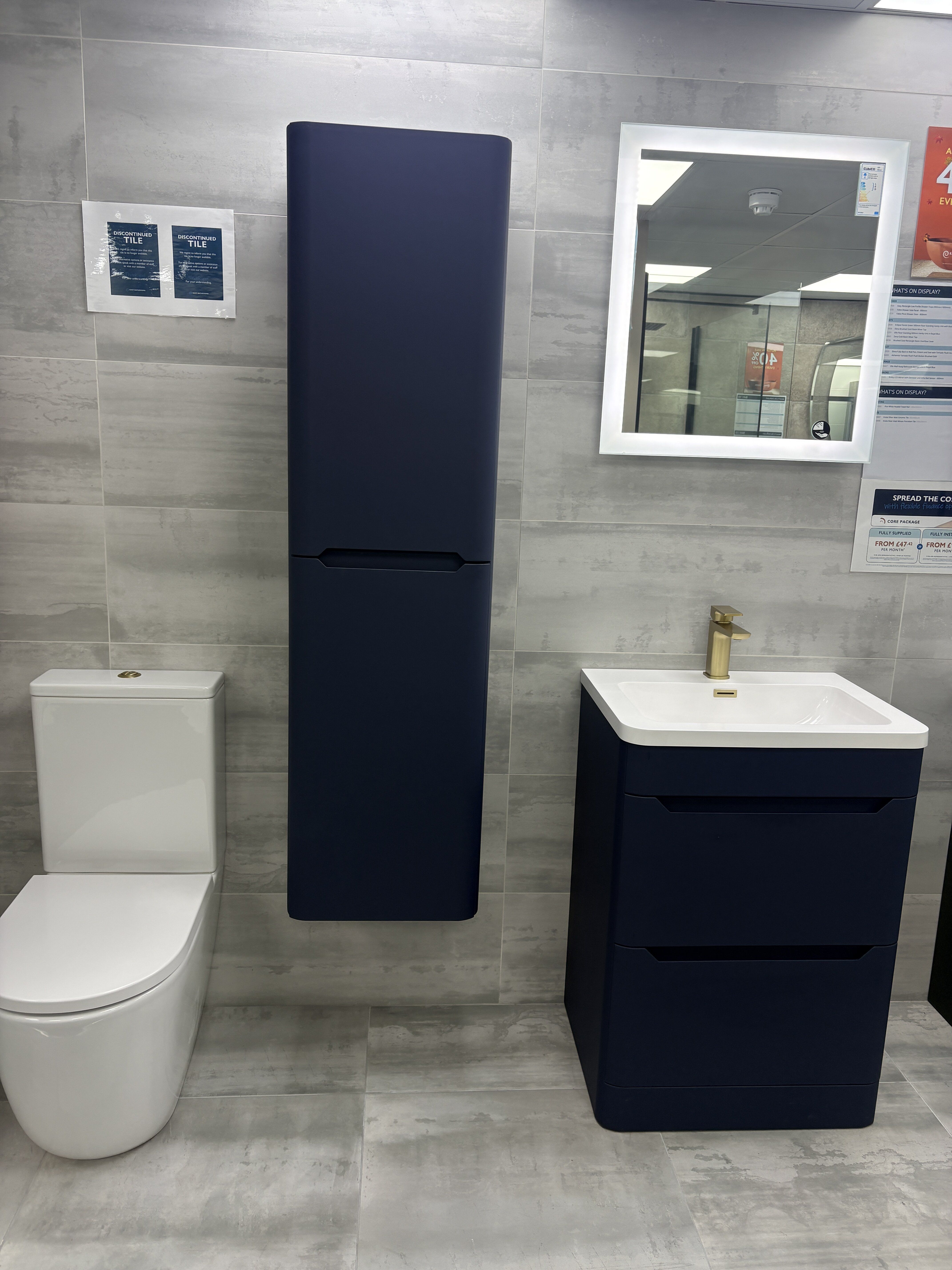 Navy blue bathroom furniture paired with brushed gold finishes at Easy Bathrooms Colchester