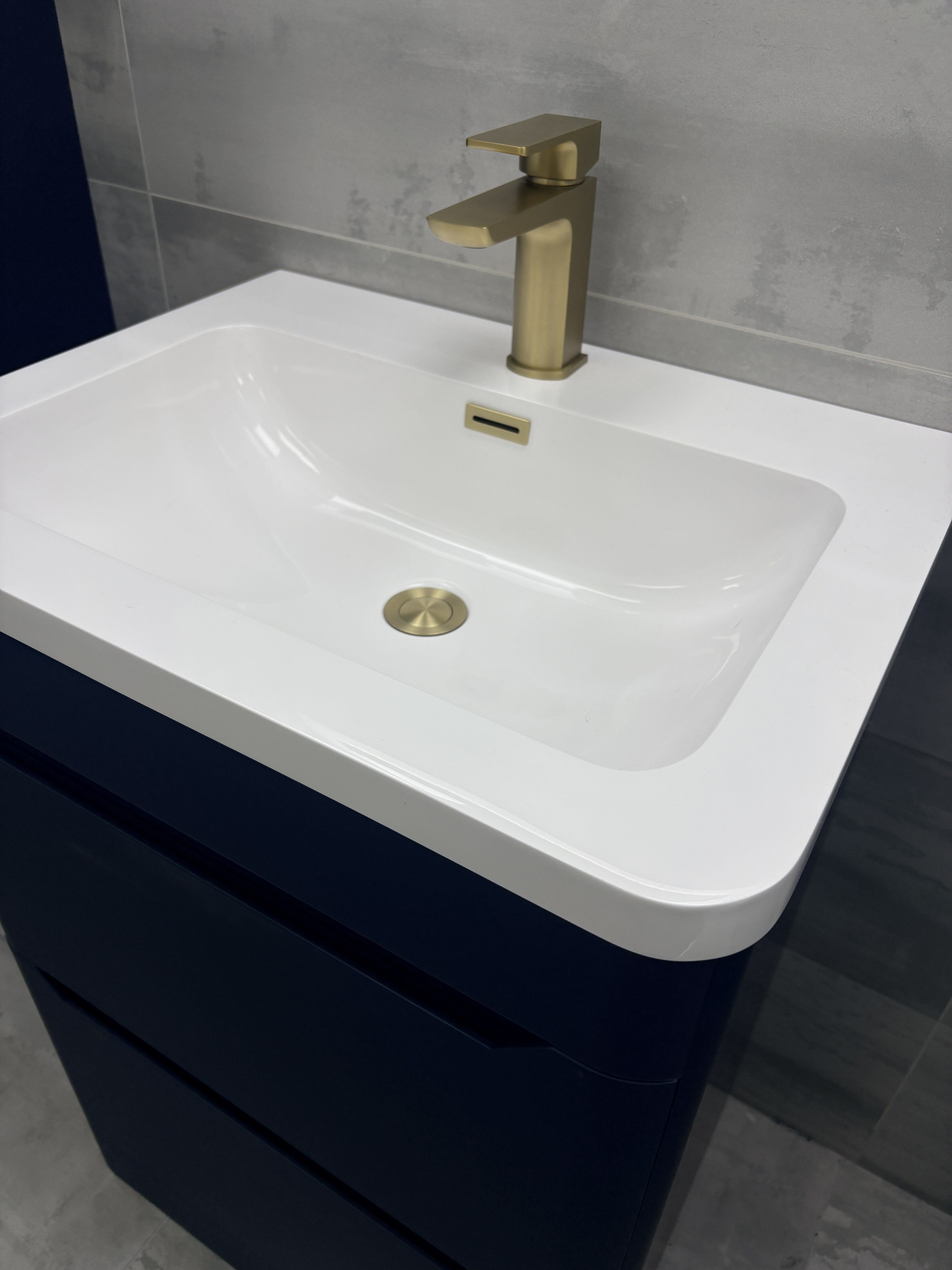Brushed gold finishes on the Ellis navy blue bathroom furniture at Easy Bathrooms Colchester