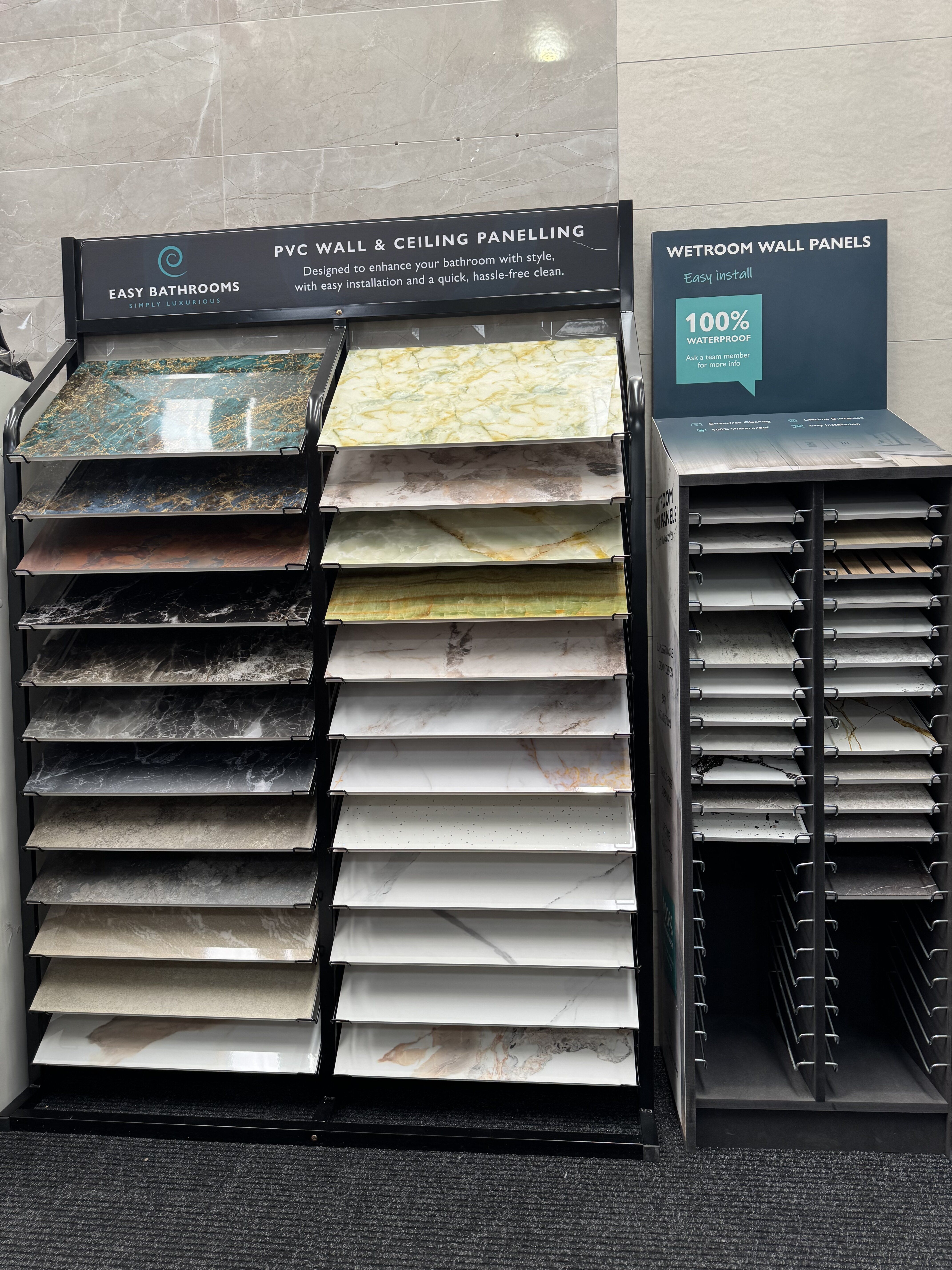 Pristina bathroom wall panel sample display at Easy Bathrooms Dereham, showing a wide range of colours, patterns and finishes.