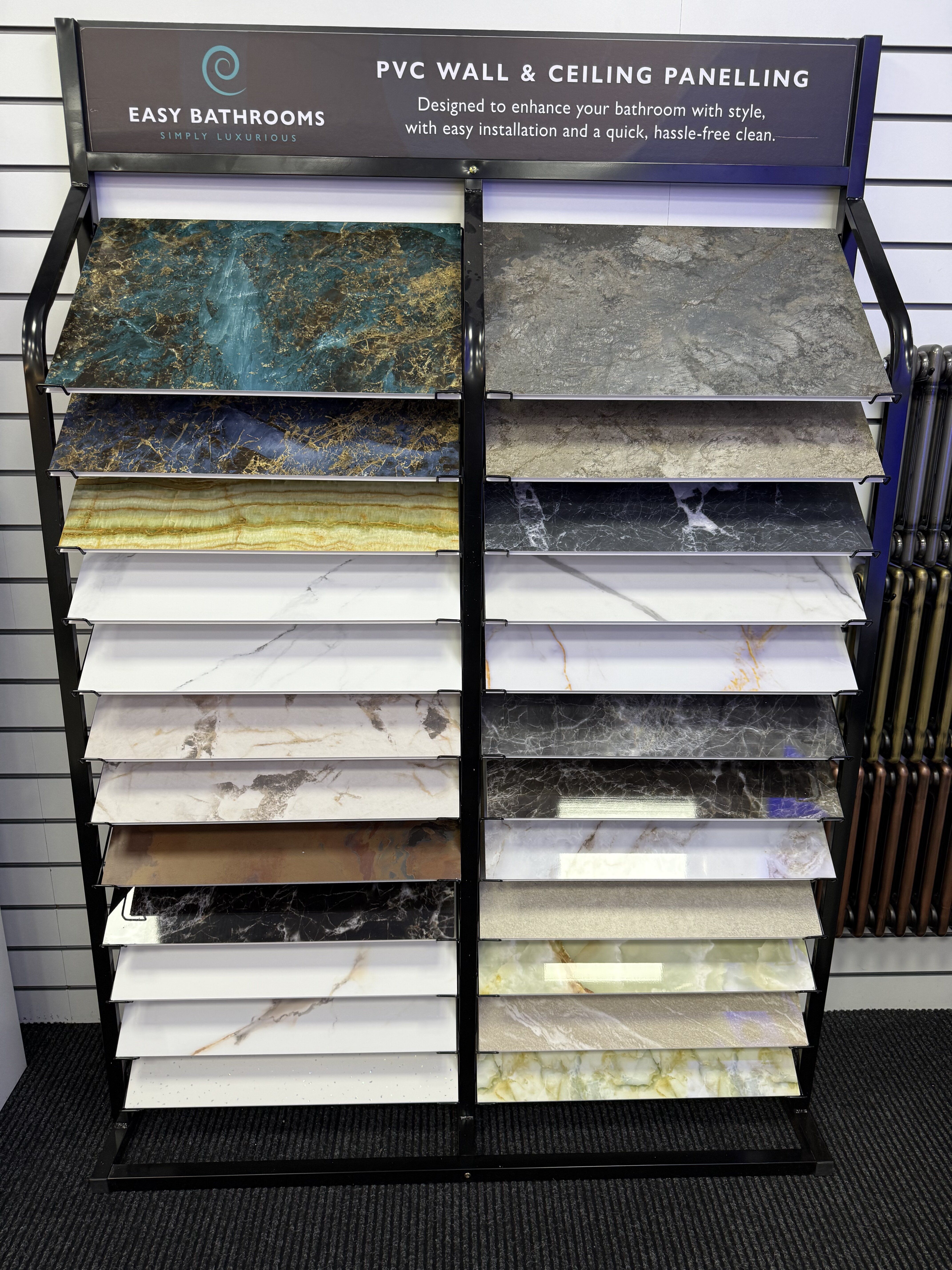 Pristina wall and ceiling panel sample display at Easy Bathrooms Romford showing a wide range of colours, stone effects and decorative finishes.