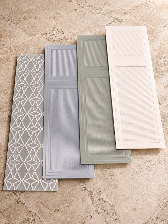 Huntsman ceramic tile samples in patterned and muted colour finishes at Easy Bathrooms Bedford.