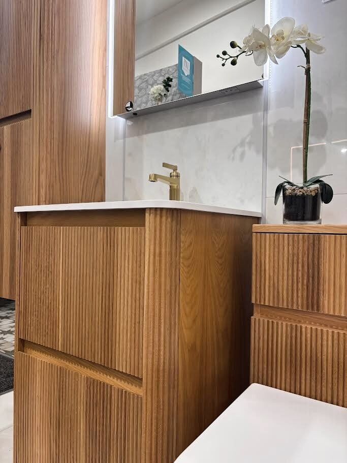 Bathroom showroom display featuring wish ribbed bathroom furniture in natural oak